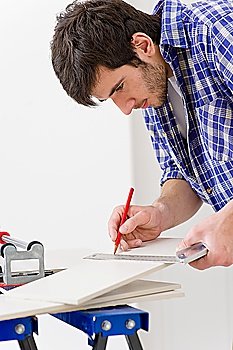Home improvement - handyman cut ceramic tile in workshop