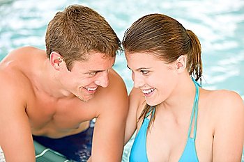 Swimming pool - young loving couple have fun on honeymoon