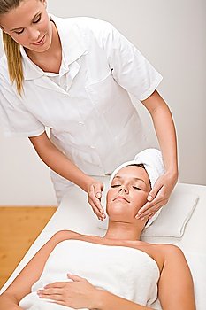Body care - woman at face massage in spa center
