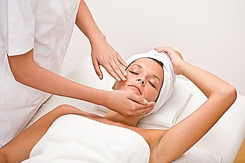 Body care - woman at face massage in spa center