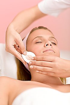 Facial care - woman cosmetics treatment in salon