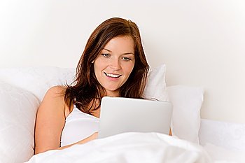 Touch screen tablet computer - woman in white bed