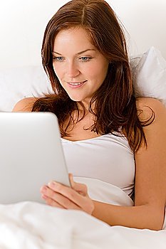 Touch screen tablet computer - woman in white bed