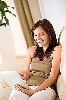 Young woman with touch screen tablet computer in lounge