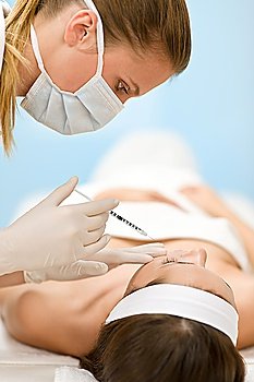 Woman in cosmetic medicine treatment getting botox injection, close-up portrait