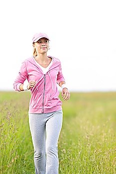 Jogging young fit woman running park field in sportswear tracksuit