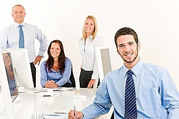 Business team happy young businessman with attractive colleagues sitting table