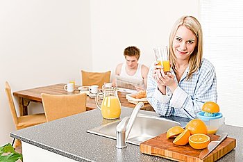 Breakfast happy couple make orange juice in morning kitchen