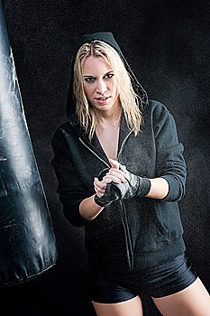Blond boxing woman prepare for training with punching bag