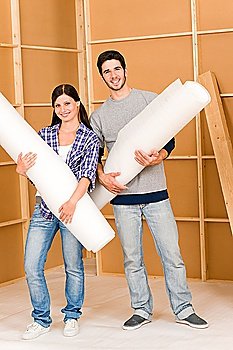Home improvement young happy couple working on floor renovations