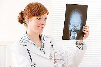 Doctor office - portrait of female physician look at x-ray