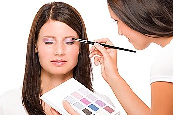 Make-up artist woman fashion model apply eyeshadow from color palette