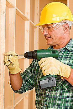 Handyman home improvement working on wall renovations using screwdriver