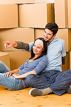 Moving into new home young happy couple sitting on floor