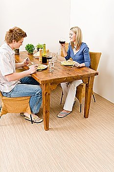 Dinner romantic couple enjoy red wine eat pasta in kitchen