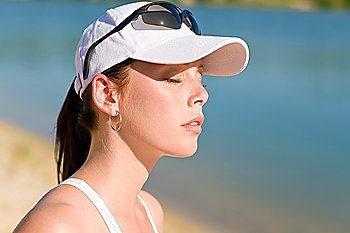 Close-up of summer active woman with cap enjoying sun