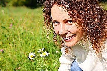 Portrait of young beauty woman with camomile outdoor