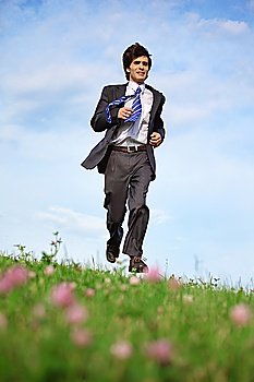 businessman runs on grass