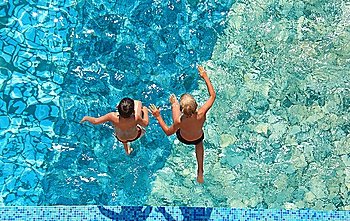 Two children jump in water,  top view