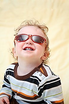 child in the sunglasses looks upward