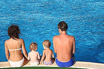 Parents and children sit at pool