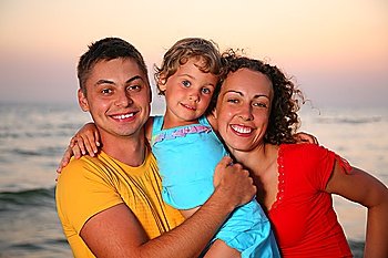 Family with little girl on sea background