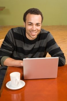 Young Man with Coffee and Laptop