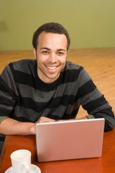 Young Man with Coffee and Laptop