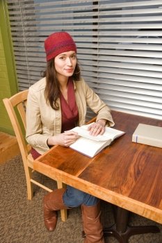 Woman Sitting at Table Reading