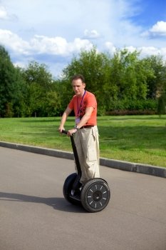 A man on an electric scooter-Segway .