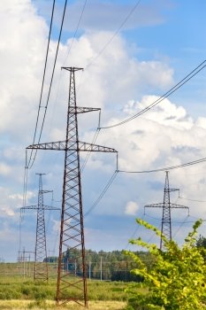 High-voltage line of electricity transmissions on field 
