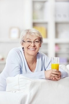 An attractive middle-aged woman with a glass of juice