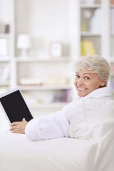 A smiling middle-aged woman with a laptop