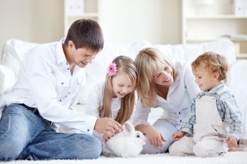Young family at home watching a rabbit