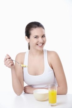 Young attractive girl breakfast corn flakes on a white background