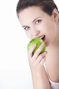 Attractive young girl eating an apple isolated