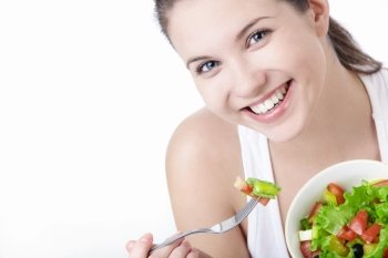 Smiling girl with a salad on a white background