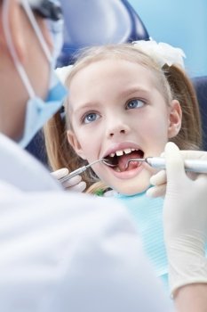 Child examines the dentist in the clinic
