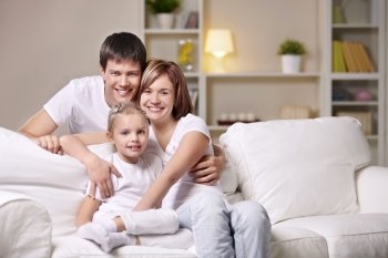 A happy family with a child at home in the evening
