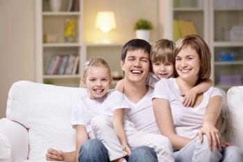 Attractive family with children at home in the evening