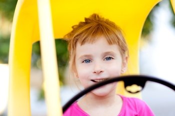 blond children girl driving toy car yellow