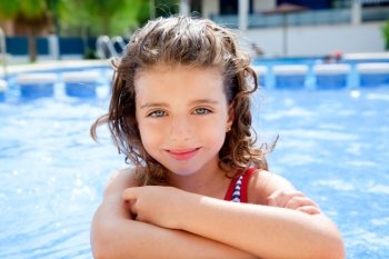 happy kid girl smiling at swimming pool in summer vacation