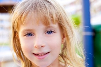 Blond beautiful kid girl portrait with blue eyes