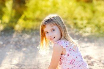 blond kid girl outdoor nature hapy portrait at sunset