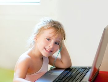 blond children girl smiling with computer laptop