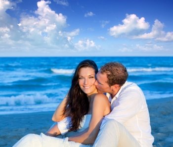 couple in love sitting in blue beach on vacation travel