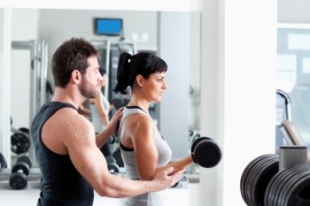gym woman personal trainer man with weight training equipment