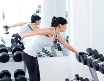 woman with weight training equipment on sport gym club