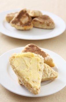 A buttered, traditional, homemade British griddle scone or girdle scone. This kind of scone is popular in Scotland and Wales