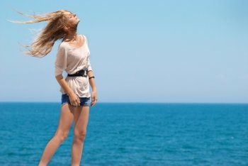Beautiful blond girl outdoors against the sea